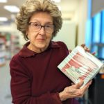 Lynne holds an audiobook at the Yardley-Makefield branch