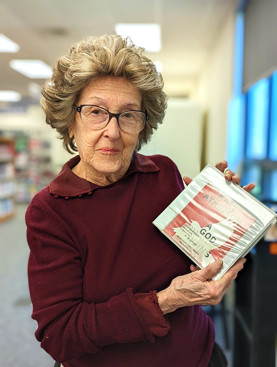 Lynne holds an audiobook at the Yardley-Makefield branch